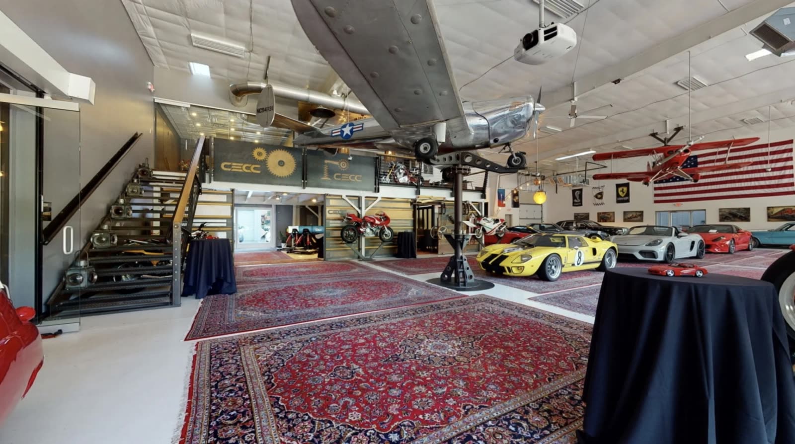 Inside the Carolina Exotic Car Club: collector cars, a suspended aircraft and event seating on the main floor